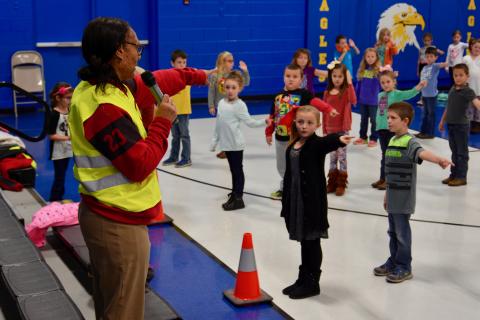 Safe Routes to School education coordinator Diana Benedict coaches Luttrell Elementary School students on hand signals for bike riding.