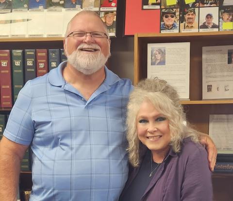 Chris Vandergriff and Cyn Taylor in front of the author's wall at the Halls Crossroads Historical Museum