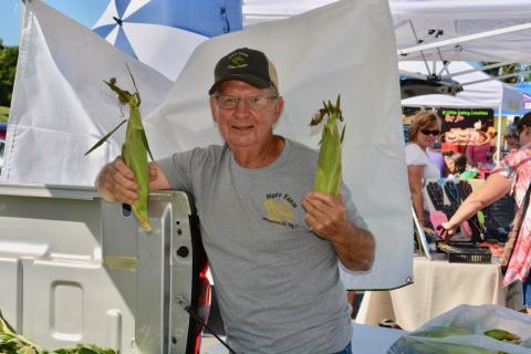 A farmer from Maryville's Huff Farms shows two ears at last year's Youth and Corn Festival.