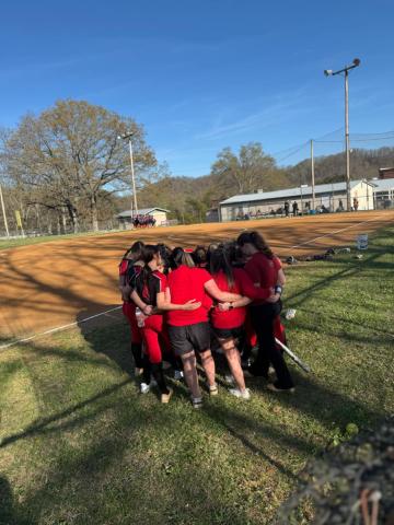 HMMS softball team in a huddle