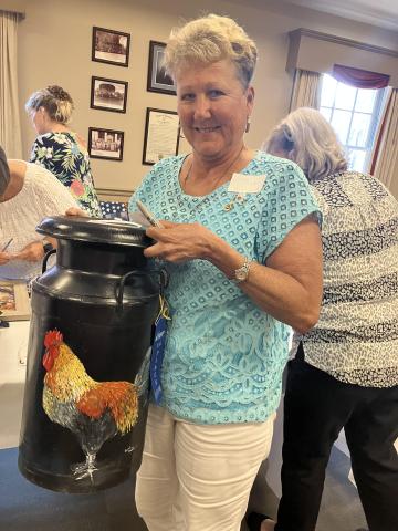 Carol Pratt proudly displaying her blue ribbon winning cultural arts entry at FCE Fall Conference