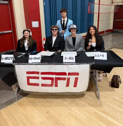 Five UC Seniors—Katie Johnson, Brandon Reed, Brady Stinnet, Brody Williams, and Graciella Linkous—dressed as ESPN reporters.