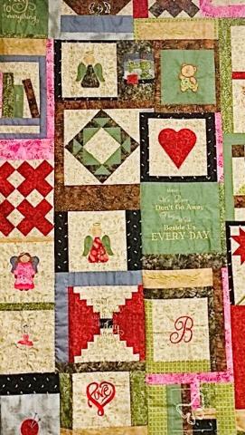 Picture of a memory quilt with hearts, initials, and other icons to remember family members