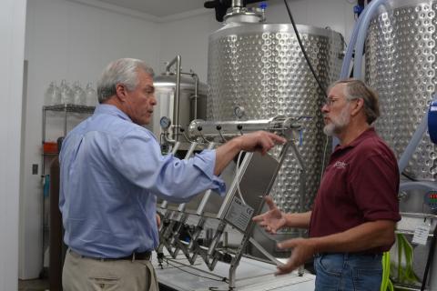 State USDA Director Jim Tracy gets a behind-the-scenes look at the Winery at Seven Springs Farm from Rick Riddle.