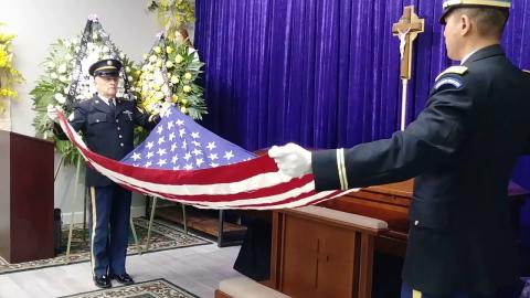 Preparing to fold flag 