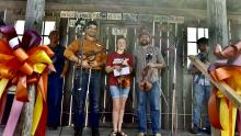 picture of an old front porch with 2019 Fiddle Contest Winners: Eric Nafzigar (2nd), Kasey Moore (1st), Austin Stovall (3rd)